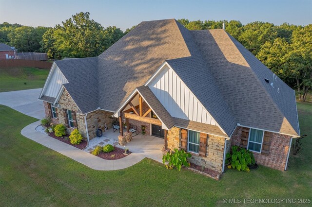 18040 County Road 1558, Ada, OK 74820 - view of front of property featuring board and batten siding, stone siding, a front yard, and a patio