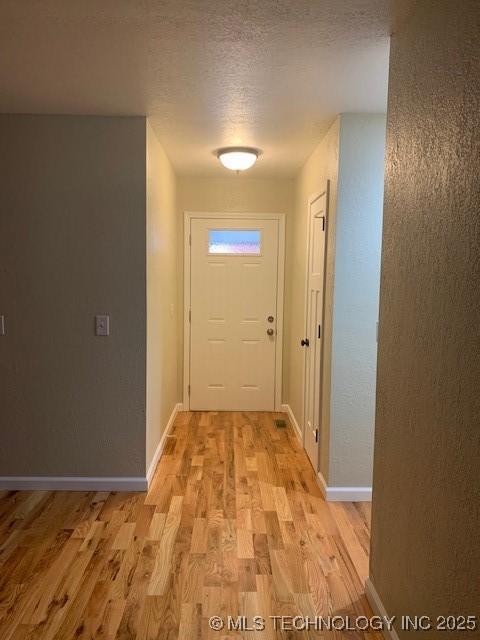 11810 E 83rd St, Owasso, OK 74055 - hallway with light wood-type flooring and a textured ceiling