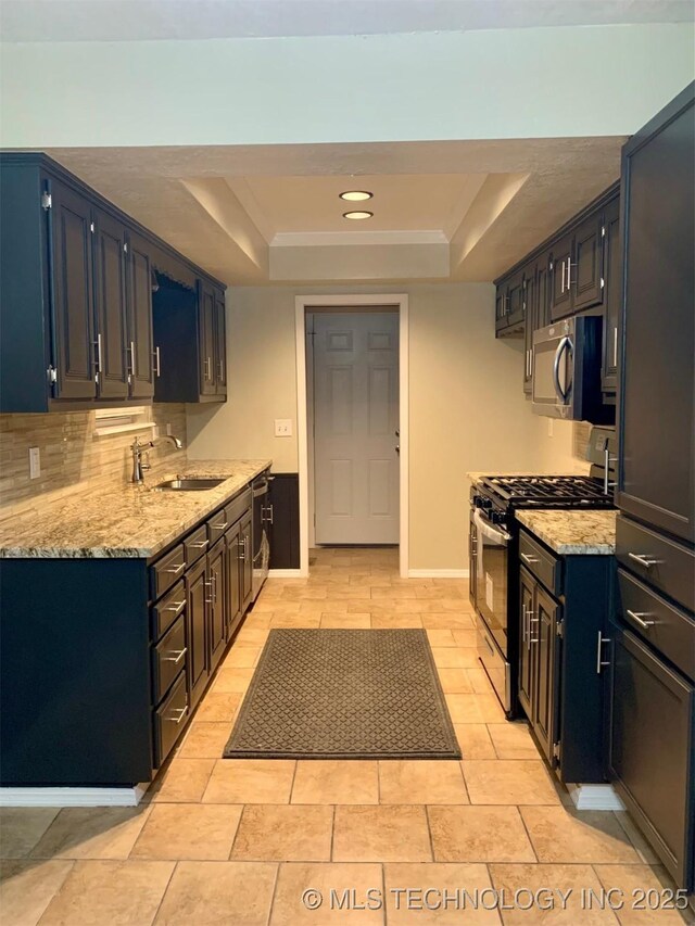 11810 E 83rd St, Owasso, OK 74055 - kitchen with stainless steel appliances, a tray ceiling, light stone countertops, decorative backsplash, and recessed lighting