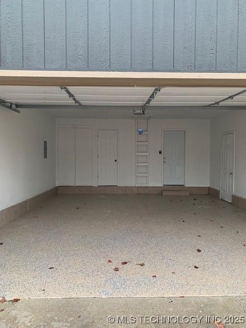 11810 E 83rd St, Owasso, OK 74055 - garage with baseboards and a garage door opener
