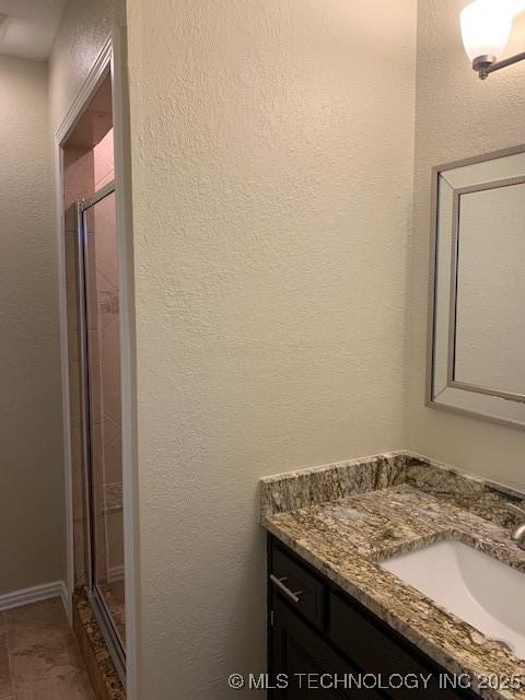 11810 E 83rd St, Owasso, OK 74055 - bathroom featuring vanity, a shower stall, and a textured wall