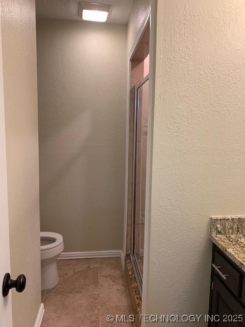 11810 E 83rd St, Owasso, OK 74055 - bathroom with a shower stall, vanity, and a textured wall