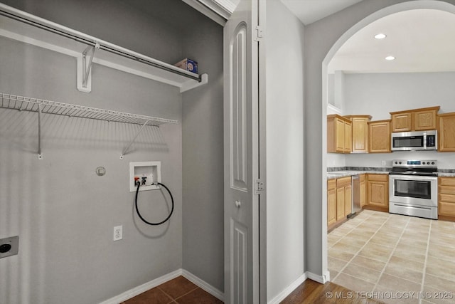 40 E Fairlane Pl, Sapulpa, OK 74066 - laundry area with hookup for a washing machine, electric dryer hookup, arched walkways, light tile patterned floors, and recessed lighting