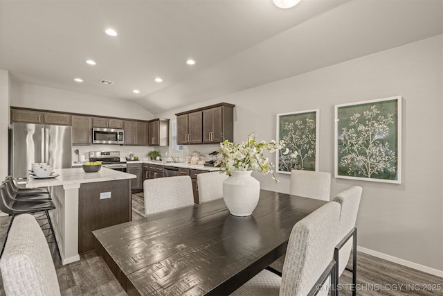 7420 E 160th Pl S, Bixby, OK 74008 - dining space with dark wood-type flooring, recessed lighting, and lofted ceiling