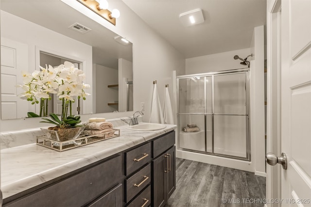 7420 E 160th Pl S, Bixby, OK 74008 - bathroom featuring vanity, wood finished floors, and a stall shower