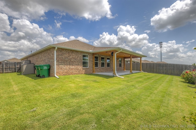 7420 E 160th Pl S, Bixby, OK 74008 - back of property featuring a patio, a fenced backyard, brick siding, and a shingled roof