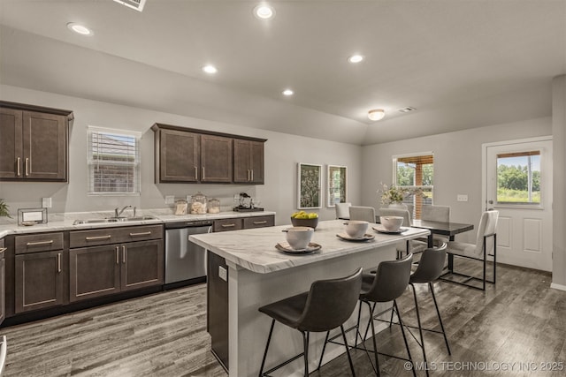 7420 E 160th Pl S, Bixby, OK 74008 - kitchen featuring stainless steel dishwasher, wood finished floors, dark brown cabinetry, a breakfast bar, and recessed lighting