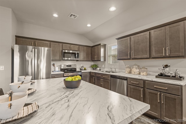 7420 E 160th Pl S, Bixby, OK 74008 - kitchen featuring stainless steel appliances, dark brown cabinetry, lofted ceiling, recessed lighting, and light stone countertops