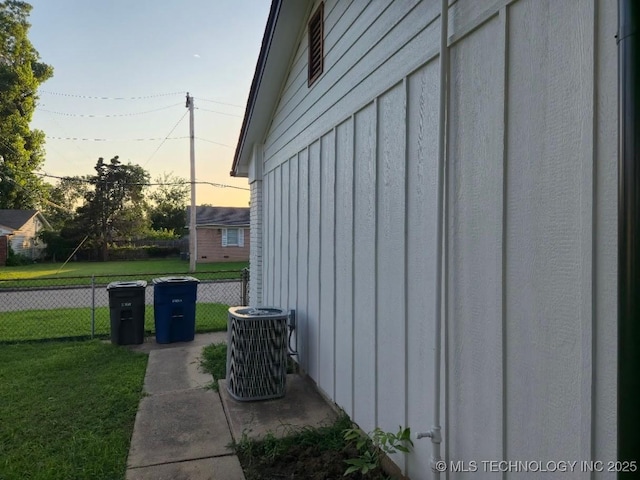 6706 E 28th Pl, Tulsa, OK 74129 - view of side of home with a central air condition unit and board and batten siding
