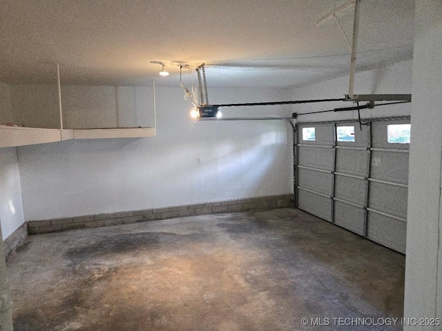 6706 E 28th Pl, Tulsa, OK 74129 - garage featuring baseboards and a garage door opener