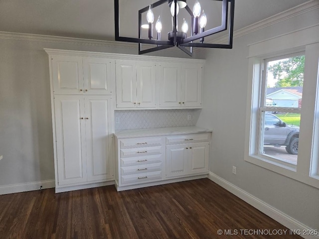 6706 E 28th Pl, Tulsa, OK 74129 - unfurnished dining area with a chandelier, dark wood-style floors, and crown molding