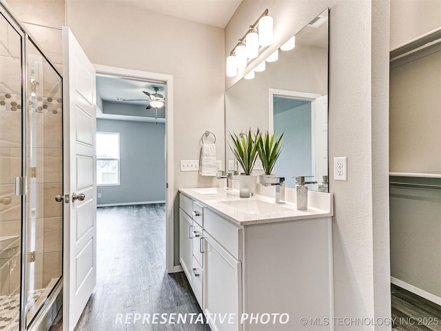 13413 S 72nd E Ave, Bixby, OK 74008 - bathroom featuring double vanity, wood finished floors, a shower stall, and ceiling fan