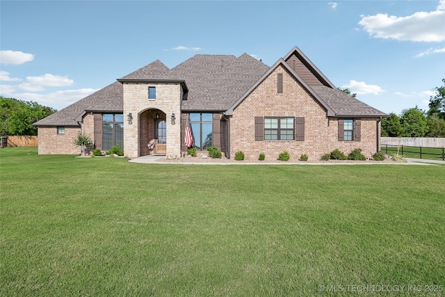20905 S Windsor Ave, Claremore, OK 74019 - french country home featuring roof with shingles and brick siding