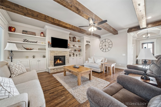 20905 S Windsor Ave, Claremore, OK 74019 - living area featuring dark wood-style floors, a fireplace, a ceiling fan, beamed ceiling, and arched walkways