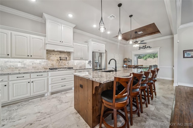20905 S Windsor Ave, Claremore, OK 74019 - kitchen with appliances with stainless steel finishes, ceiling fan, decorative backsplash, ornamental molding, and white cabinets