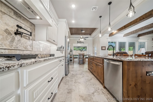 20905 S Windsor Ave, Claremore, OK 74019 - kitchen with appliances with stainless steel finishes, ventilation hood, crown molding, decorative backsplash, and light stone countertops