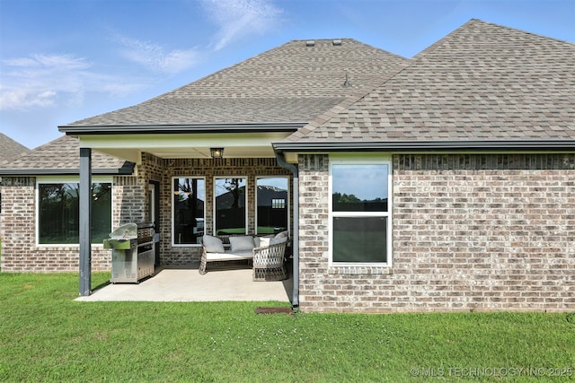 14109 N 72nd E Ave, Collinsville, OK 74021 - back of property with a shingled roof, brick siding, a lawn, and a patio
