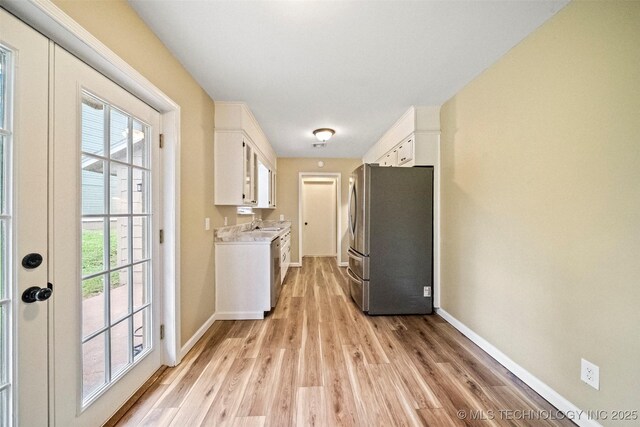 2003 Charlestown Cir, Claremore, OK 74017 - washroom with cabinet space, light wood-style floors, and washer and clothes dryer