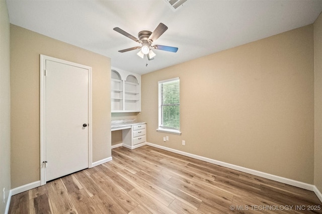 2003 Charlestown Cir, Claremore, OK 74017 - unfurnished bedroom with built in study area, light wood finished floors, and a ceiling fan