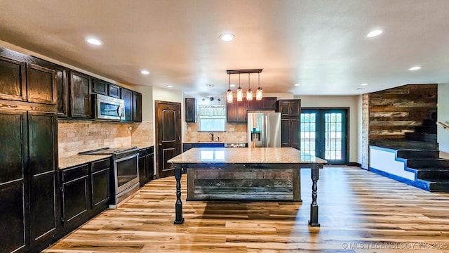 5068 E 188th St S, Warner, OK 74469 - kitchen with stainless steel appliances, light wood finished floors, light stone countertops, and recessed lighting