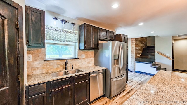 5068 E 188th St S, Warner, OK 74469 - kitchen with appliances with stainless steel finishes, light wood-type flooring, tasteful backsplash, dark brown cabinets, and recessed lighting