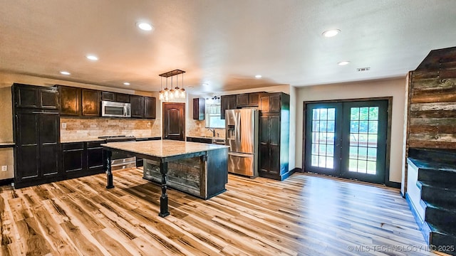 5068 E 188th St S, Warner, OK 74469 - kitchen featuring stainless steel appliances, recessed lighting, a breakfast bar area, light wood-style floors, and decorative backsplash