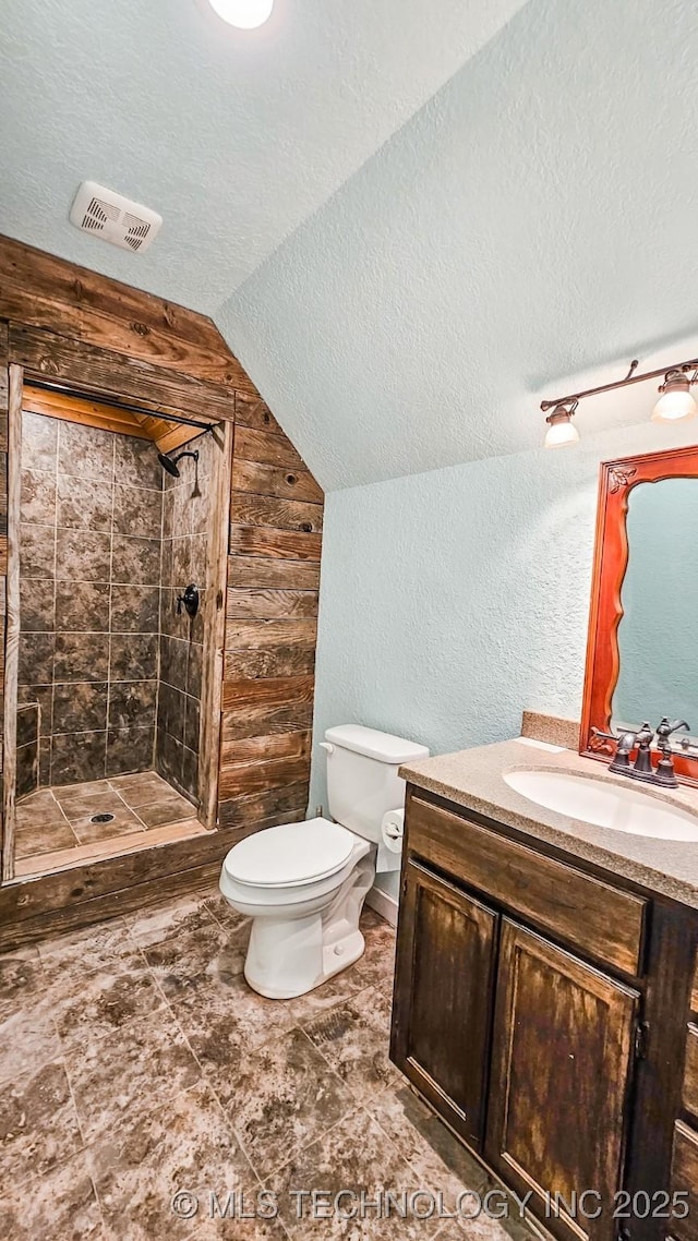 5068 E 188th St S, Warner, OK 74469 - bathroom with lofted ceiling, a stall shower, vanity, wooden walls, and a textured wall