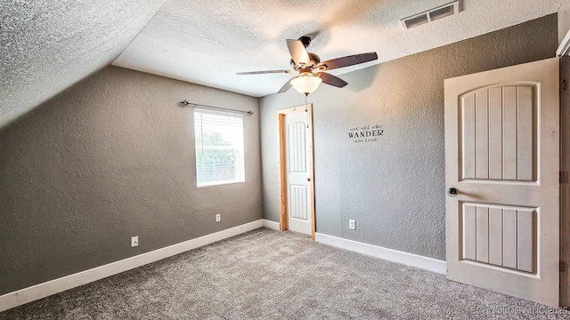 5068 E 188th St S, Warner, OK 74469 - unfurnished bedroom with a textured wall, a textured ceiling, carpet flooring, lofted ceiling, and ceiling fan