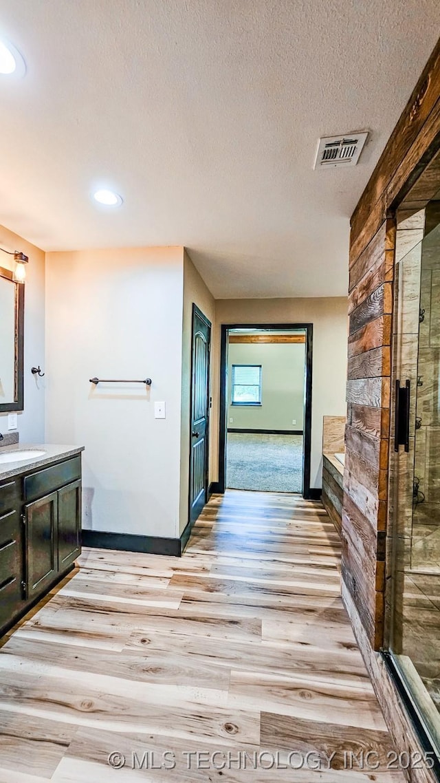 5068 E 188th St S, Warner, OK 74469 - full bath featuring wood finished floors, vanity, a stall shower, recessed lighting, and a textured ceiling
