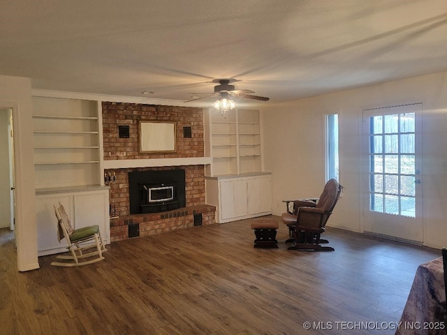 1604 S 5th St, Mcalester, OK 74501 - unfurnished room with built in features, wood finished floors, a ceiling fan, and a brick fireplace