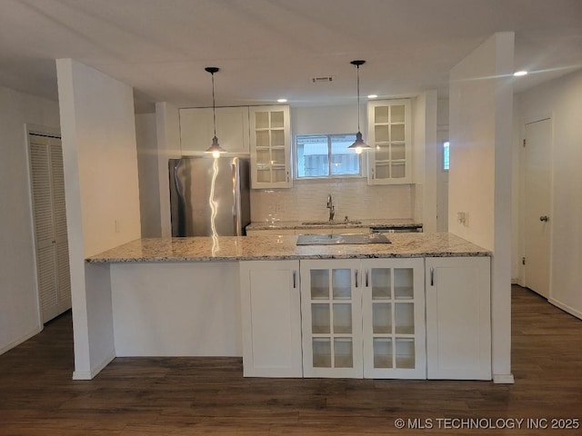 1604 S 5th St, Mcalester, OK 74501 - kitchen featuring freestanding refrigerator, white cabinets, glass insert cabinets, and tasteful backsplash