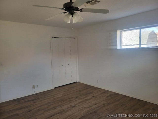 1604 S 5th St, Mcalester, OK 74501 - unfurnished bedroom with dark wood-style floors, a closet, and ceiling fan