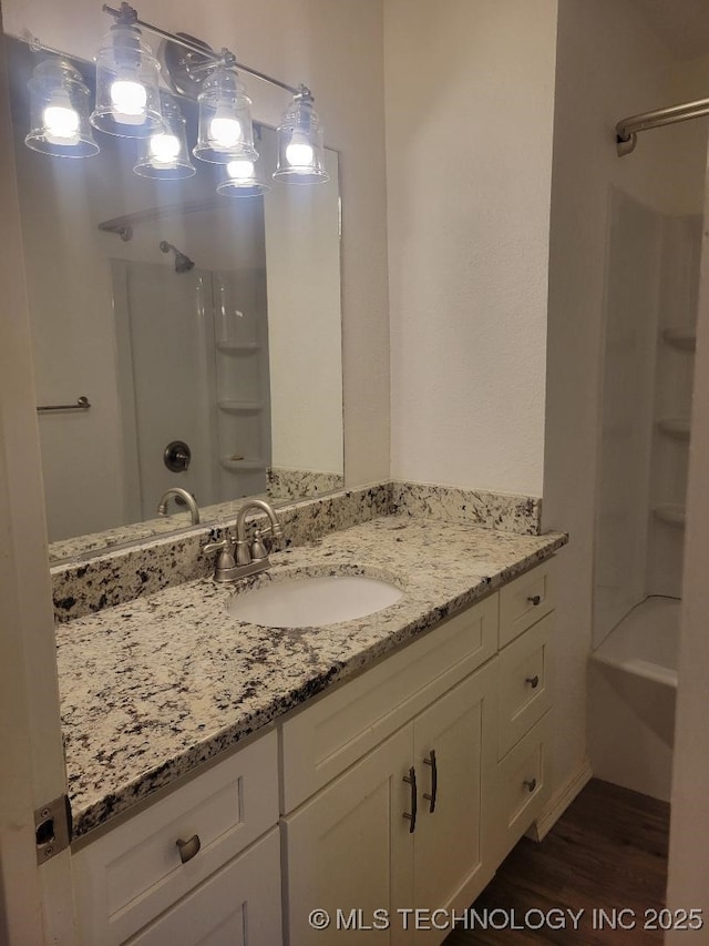 1604 S 5th St, Mcalester, OK 74501 - full bath with vanity, wood finished floors, and bathtub / shower combination