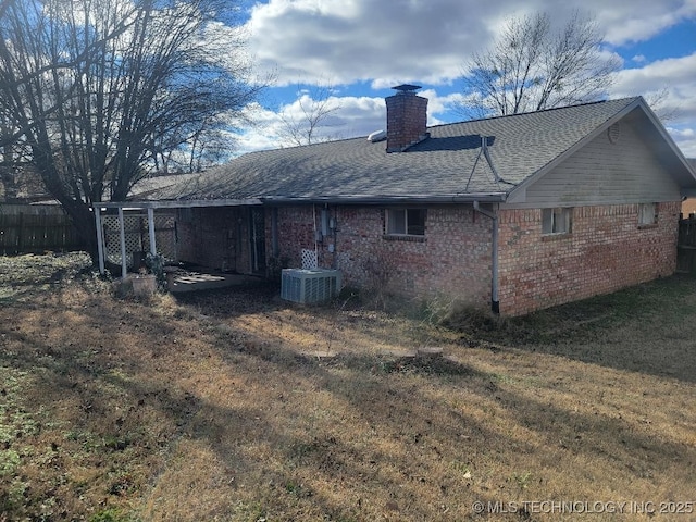 1604 S 5th St, Mcalester, OK 74501 - rear view of property featuring a chimney, brick siding, and roof with shingles