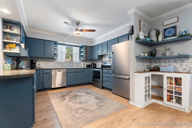 1934 Birnamwood, Miami, OK 74354 - kitchen featuring open shelves, stainless steel appliances, blue cabinets, ornamental molding, and a ceiling fan