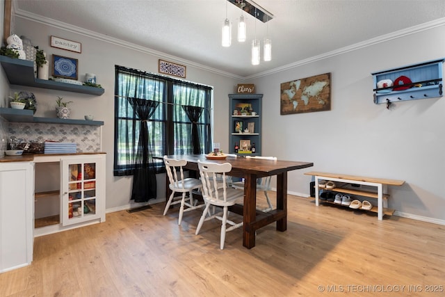 1934 Birnamwood, Miami, OK 74354 - dining room featuring ornamental molding, wood finished floors, and a textured ceiling