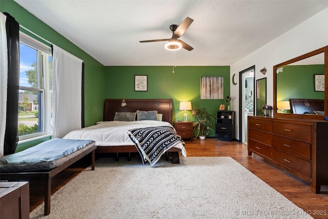 1934 Birnamwood, Miami, OK 74354 - bedroom featuring wood finished floors, ceiling fan, and a textured ceiling