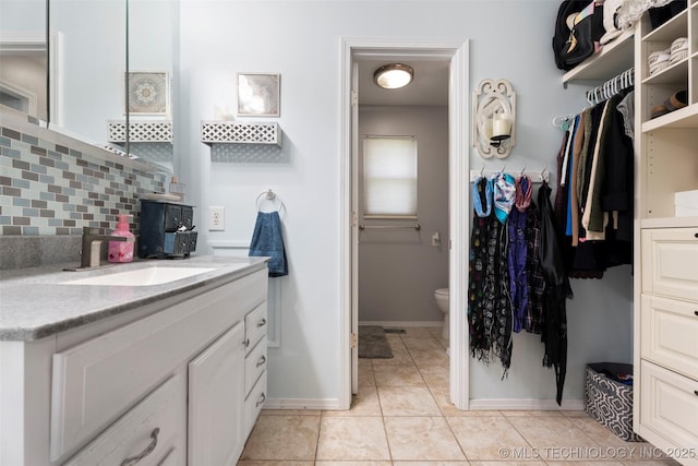 1934 Birnamwood, Miami, OK 74354 - full bathroom with vanity, a walk in closet, and tile patterned flooring