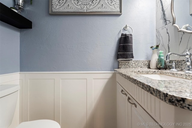 1934 Birnamwood, Miami, OK 74354 - half bath with vanity, a wainscoted wall, and a decorative wall