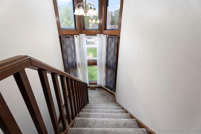 1934 Birnamwood, Miami, OK 74354 - stairway with carpet floors and a chandelier