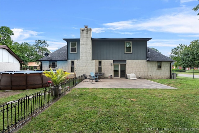1934 Birnamwood, Miami, OK 74354 - rear view of house featuring brick siding, a chimney, a fenced backyard, and a patio