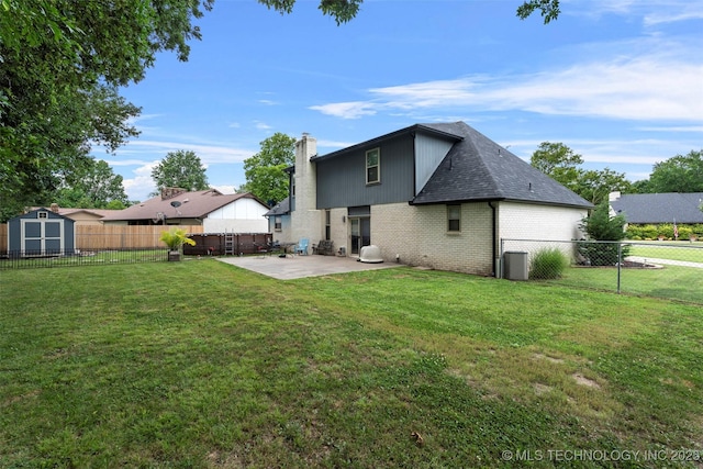 1934 Birnamwood, Miami, OK 74354 - back of house featuring brick siding, a patio, a storage unit, a fenced backyard, and a chimney