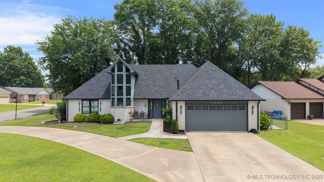 1934 Birnamwood, Miami, OK 74354 - view of front of property featuring brick siding, a shingled roof, and a garage