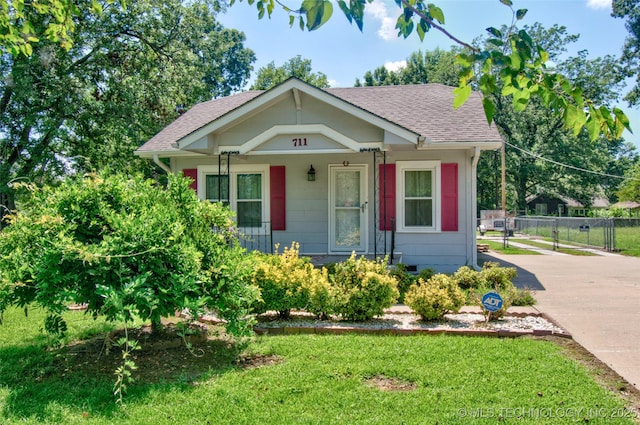 711 S 29th St W, Muskogee, OK 74401 - bungalow-style home featuring a shingled roof, driveway, and covered porch