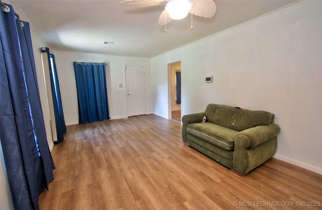711 S 29th St W, Muskogee, OK 74401 - living area featuring light wood-style floors, ceiling fan, and ornamental molding