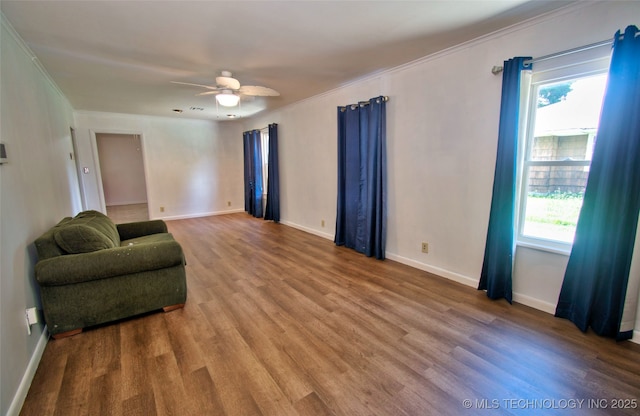 711 S 29th St W, Muskogee, OK 74401 - sitting room with plenty of natural light, ornamental molding, wood finished floors, and ceiling fan