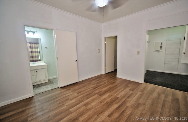 711 S 29th St W, Muskogee, OK 74401 - unfurnished bedroom featuring wood finished floors, ornamental molding, and ensuite bathroom