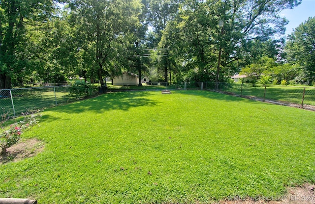 711 S 29th St W, Muskogee, OK 74401 - fenced backyard featuring view of wooded area