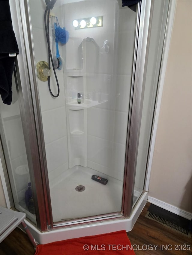 617 N 11th St, Pawnee, OK 74058 - bathroom with a shower stall and wood finished floors