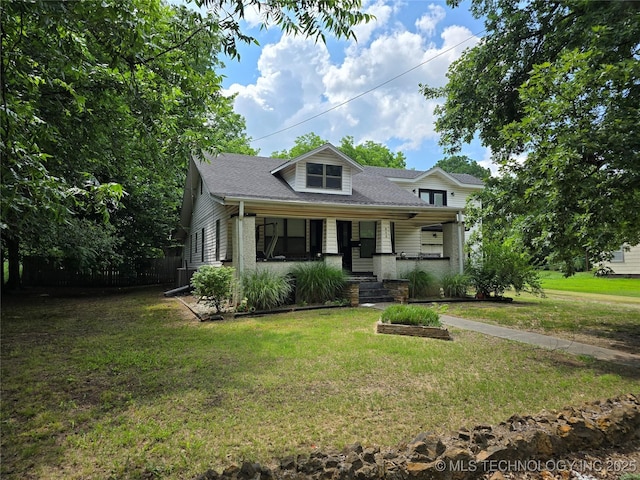 617 N 11th St, Pawnee, OK 74058 - view of front facade featuring covered porch, roof with shingles, and a front lawn